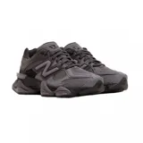 Championes New Balance modelo 9060, de color negro y gris oscuro, con diseño robusto de inspiración chunky, suela esculpida y el característico logotipo "N" en los laterales.
