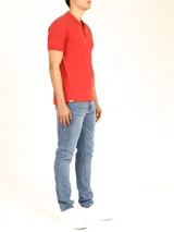 Polo de piqué color rojo, de manga corta y botones al tono.