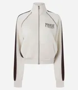 Campera deportiva de cuello alto con cierre frontal y bolsillos tipo canguro, en color beige con detalles marrones en las mangas y estampa localizada con texto "Phoenix Arizona".