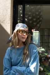 Lentes de sol con montura gruesa de forma cuadrada/rectangular, color verde oliva translúcido, y cristales tintados en tono ámbar/marrón claro.