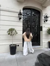 Pantalón sastrero marrón de corte palazzo, con botón, pasacinto y pretina trasera con elástico.