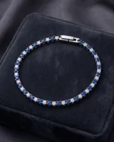 Pulsera de acero finamente engastada con circonias blancas y azules alternadas en toda su longitud.