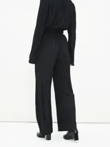 Pantalón de vestir color borgoña, de corte palazzo y tela plisada.