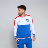 Buzo de cuello redondo Umbro del Club Nacional de Football. Diseño tricolor con cuerpo superior blanco, franja central azul y detalles en rojo en hombros y puños. Incluye logo de Umbro y escudo del club en el pecho.