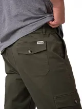 Pantalon cargo de corte ajustado en color verde militar. Presenta bolsillos laterales tipo cargo con solapa, bolsillos frontales y traseros, cierre de cremallera con botón y cintura con elástico interior para mayor comodidad.