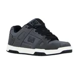 Championes de skate DC modelo Stag, color gris con detalles en negro. Presentan una construcción robusta con paneles de cuero y gamuza, perforaciones para ventilación, logo de la marca en el lateral y suela de goma con entresuela blanca.