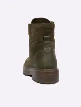 Borcego de gamuza color tostado, con cordones al tono y suela de goma dentada.