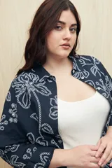 Camisa de manga larga azul marino con estampado floral blanco, de corte clásico y botones frontales.