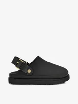 Zueco de la marca UGG modelo Goldenstar, confeccionado en cuero nobuck negro. Presenta una suela de plataforma de EVA ultra liviana y una correa trasera ajustable con hebilla metálica dorada.