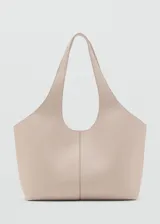 Bolso tipo tote bag color beige con textura granulada, diseño minimalista y asas integradas.
