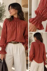 Blusa de seda color rojo terracota con diseño de rayas verticales blancas, cuello smock fruncido y mangas largas amplias con puños elásticos fruncidos.