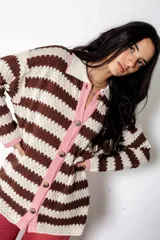 Camisa de algodón con rayas tejidas horizontales en tonos marrón chocolate y crudo. Presenta cuello y cierre frontal con botones.