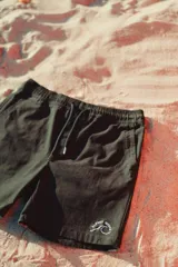 Bermuda negra de corte recto con cordón ajustable en la cintura y logo bordado en blanco en la pierna izquierda.