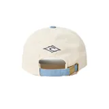 Gorra de gabardina color crema con visera curva azul y logo de Rip Curl bordado en el frente.