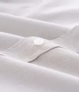 Camisa de vestir masculina de manga larga, confeccionada en tricolina con un sutil estampado de cuadros grid. Presenta cuello clásico, abotonadura frontal y puños con botones.