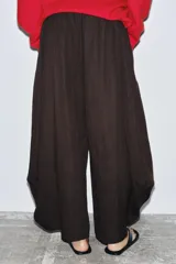 Pantalón de mujer color marrón oscuro, tiro medio, con cintura elástica y pierna ancha con mucho volumen y caída.