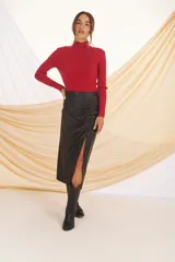 Sweater rojo de punto con cuello alto y mangas largas. Presenta detalles de costuras verticales en color azul en la parte delantera y en los hombros.