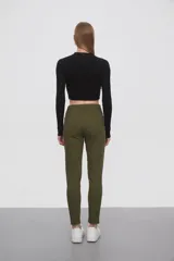 Pantalon de jean negro, corte skinny y tiro medio, con cierre frontal y bolsillos laterales.