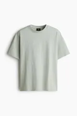 Remera de algodón pesado color verde menta, con cuello redondo ribeteado, hombros caídos y corte holgado.