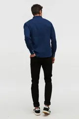 Jean skinny negro de tiro medio, con cierre de botón y cremallera, y bolsillos delanteros y traseros.