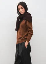 Pantalón de cuero sintético negro de corte recto, con cintura elástica ajustable mediante cordón y bolsillos laterales.