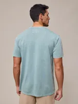 Remera básica de cuello redondo con bolsillo frontal, confeccionada en algodón con efecto de lavado gastado.