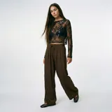 Pantalón marrón de corte ancho y tiro alto, con cintura elástica y cordón ajustable.