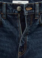 Jeans de tiro alto y corte recto, confeccionados en tejido de algodón estilo denim en color azul oscuro con efecto lavado. Presentan diseño de cinco bolsillos, cierre frontal con cremallera y botón, y trabillas para cinturón.
