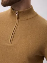 Sweater de tejido de punto color tostado, con cuello alto y cierre frontal parcial. Presenta mangas largas con puños acanalados y un diseño de corte clásico.