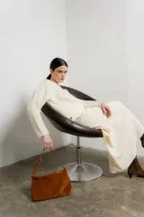 Sweater de punto color crudo, de corte holgado y mangas largas.