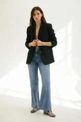 Blazer negro con bordado floral, hombreras, bolsillo interno y botones frontales y en mangas.