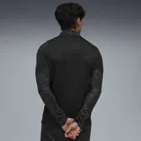Buzo deportivo de manga larga, color negro, con cuello alto y cierre parcial de un cuarto (1/4 zip). Las mangas presentan paneles laterales con textura de malla.