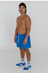 Short de baño celeste con cintura elástica y cordón ajustable.