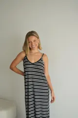 Vestido largo de jersey, color negro con rayas horizontales blancas, corte recto y tirantes finos.