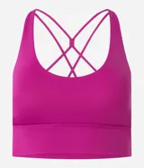 Top deportivo alargado color fucsia, con escote en U y cintura ancha. Posee tiras finas cruzadas en la espalda y copas removibles.