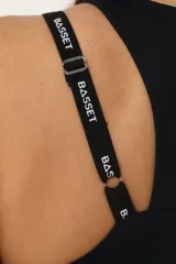Top deportivo negro con espalda cruzada, elástico inferior y tiras regulables con logo Basset.