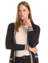 Cardigan de tejido acanalado en color negro, con diseño abierto y manga larga. Presenta detalles de ribete con patrón geométrico en contraste a lo largo de la apertura frontal, en los puños y en los bolsillos simulados.