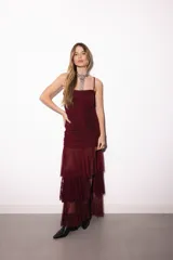 Vestido midi con diseño fruncido en toda la prenda, estampado en tonos tierra y marrones, escote recto con tirantes finos removibles y tajo lateral en la falda.