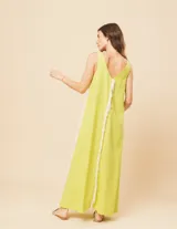 Vestido largo blanco de lino con escote en V y flecos de algodón en los bordes.