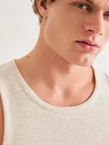 Musculosa blanca de corte slim, confeccionada en tela acanalada (tejido de punto con textura de canalé).