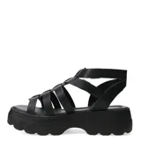Sandalias tipo franciscanas de cuero negro con plataforma track y doble tira con hebilla metálica en el tobillo.