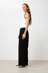 Pantalón negro de lino, corte palazzo, con cintura elástica y cordón ajustable.