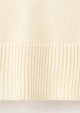 Jersey de punto de cuello alto, con diseño recto, manga larga y aberturas laterales en el ruedo.