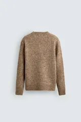 Jersey de punto regular fit, confeccionado en una mezcla de lana y fibra de alpaca. Presenta cuello redondo, manga larga y acabados en rib en puños y bajo.
