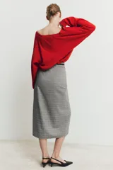Jersey de punto liso con escote en V profundo y mangas largas, con terminaciones en rib en puños y ruedo.