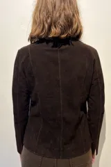 Blazer de gamuza color chocolate, con cuello camisero, cierre frontal de botones claros y corte recto.