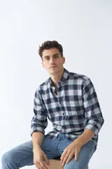 Camisa de viyela a cuadros azul, celeste y rojo, de corte regular, manga larga, con bolsillo en el pecho y logo bordado.