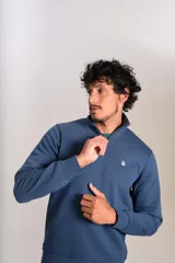Buzo de cuello alto con cierre frontal parcial, manga larga y puños acanalados. Presenta el logo de la marca bordado en el pecho.