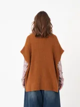 Chaleco tipo poncho de tejido de punto color tostado, con cuello polera y diseño holgado con laterales abiertos.