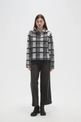 Sweater de tejido jacquard con diseño de cuadros, cuello solapa y cierre frontal parcial. Presenta un corte holgado y mangas largas.